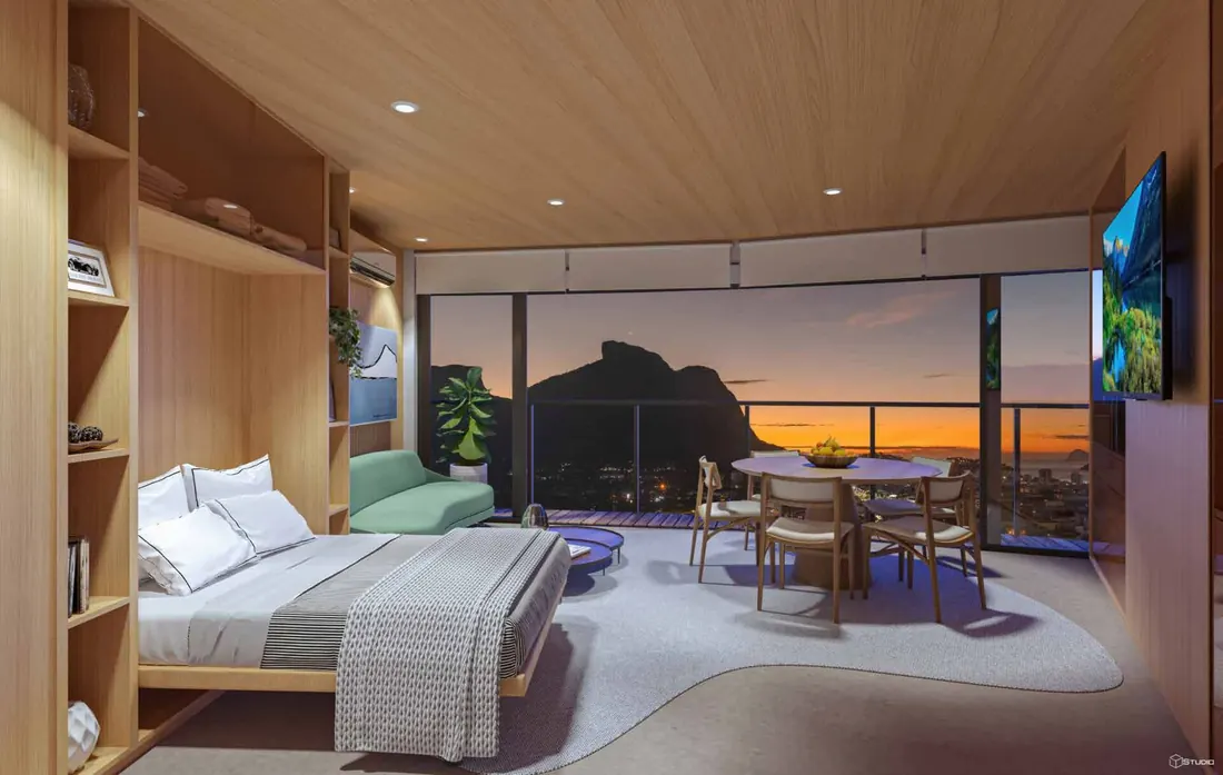 Studio do Niemeyer 360° Residences com esquadria de piso a teto e vista para as montanhas ao pôr do sol